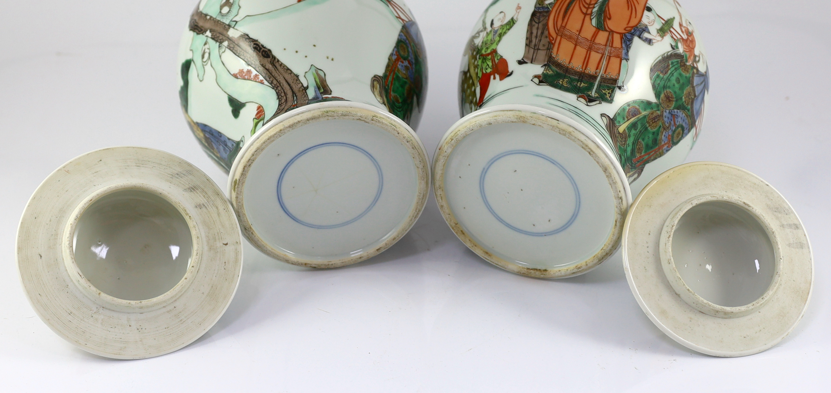 A pair of Chinese famille verte ‘Sanxing’ vases and covers, 19th century, some cracks